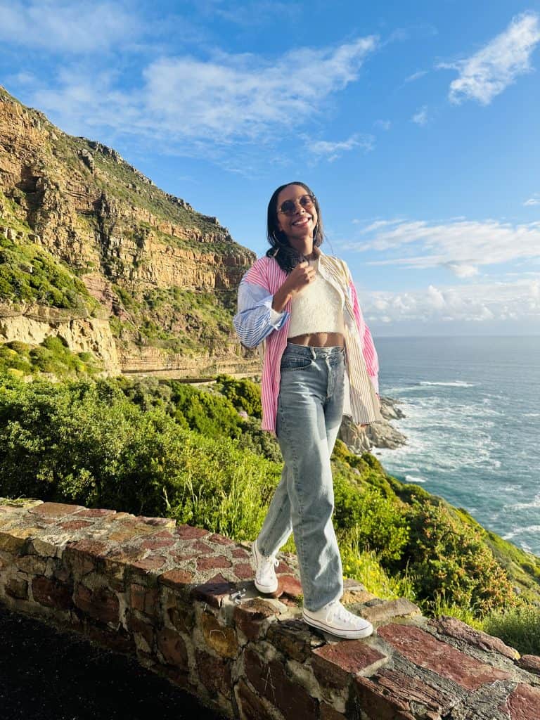 woman standing along cliff at Chapman's Peak
