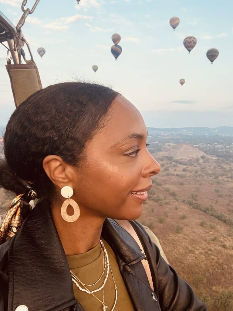 woman in hot air balloon over Teotihuacán Pyramids