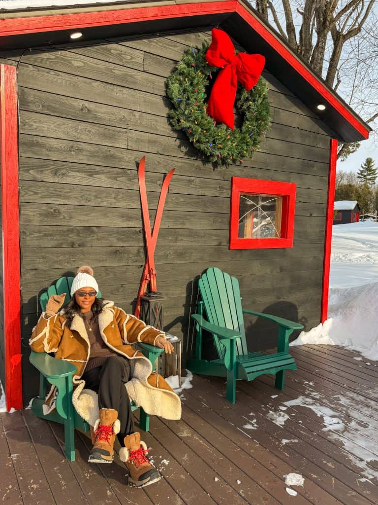 woman sitting down in front of home